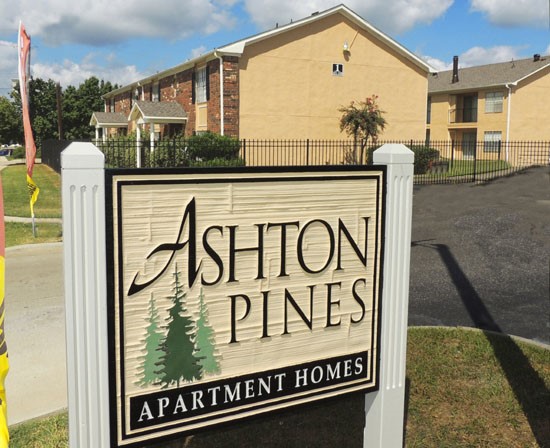 Ashton Pines beautiful front sign with green trees painted on